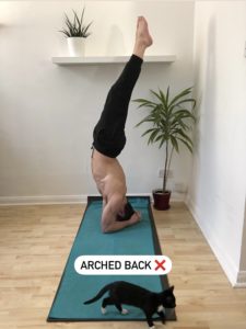 An arch in headstand can cause lower back pain.