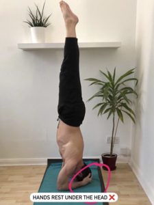 In a headstand the hands should not be underneath the head.